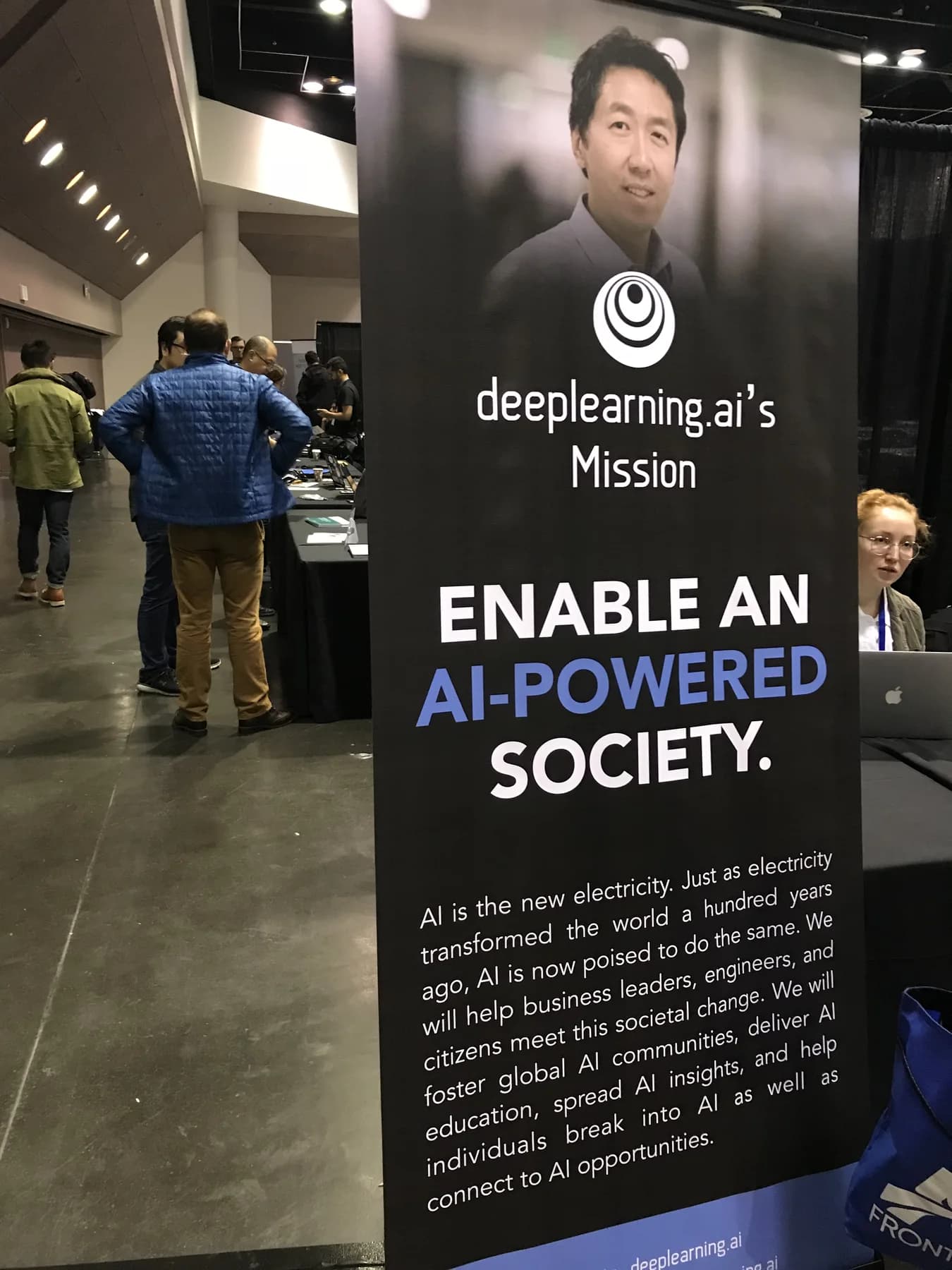 A deeplearning.ai sign at AI Frontiers 2017 describing a mission to enable an AI-powered society.