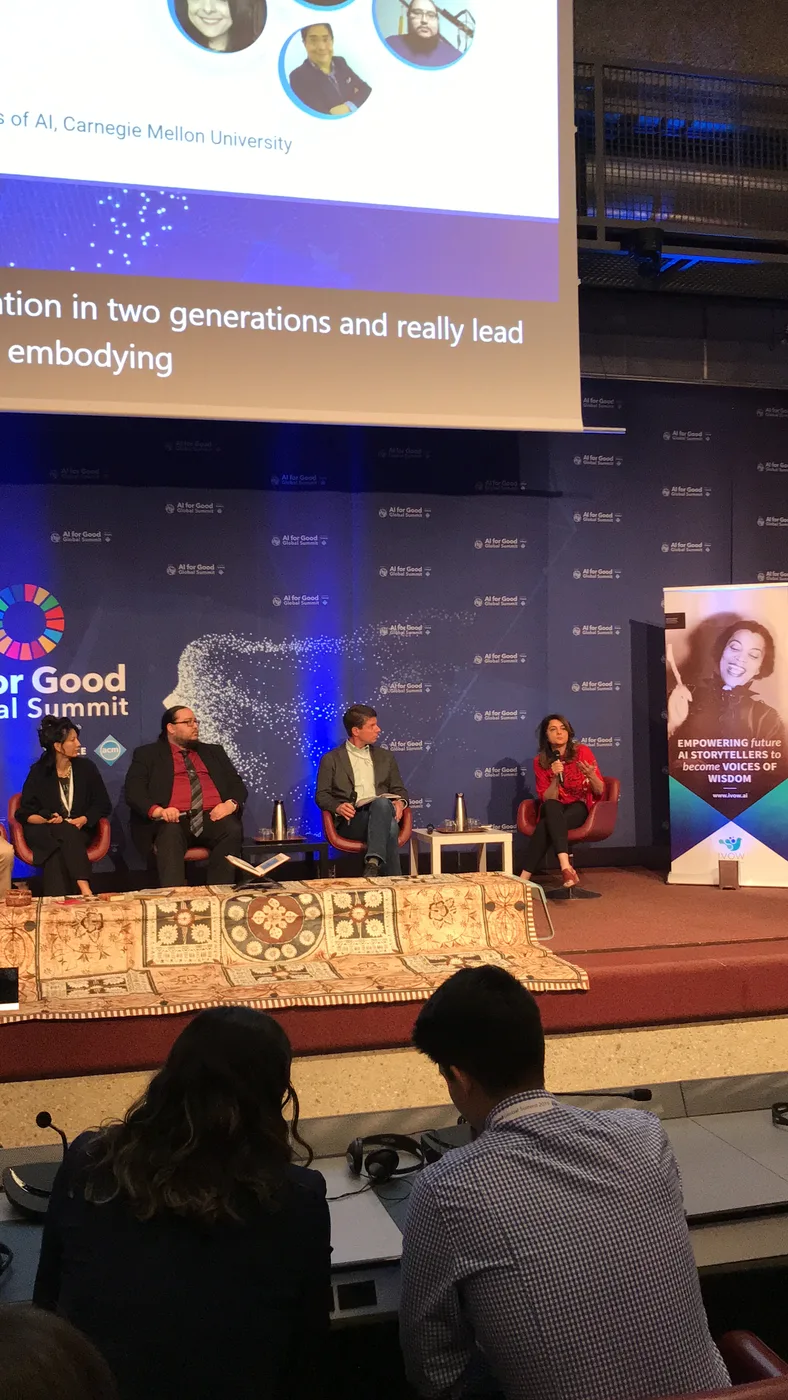 AI for Good panelists discussing storytelling and AI systems on stage